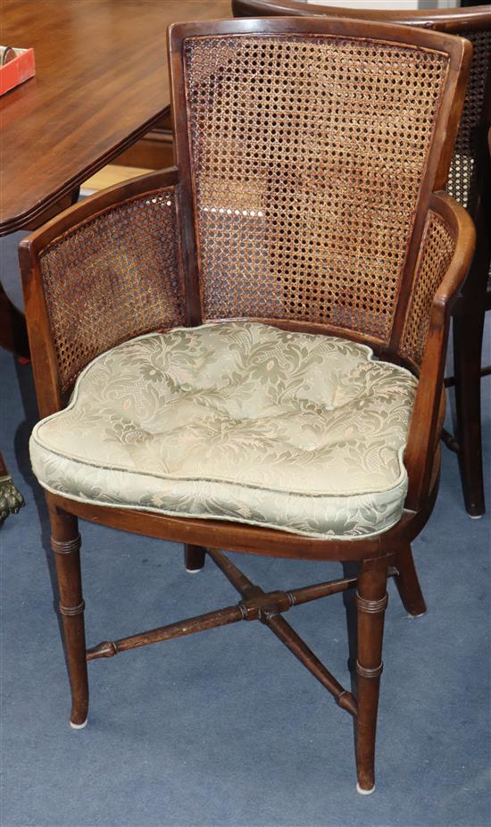 A set of eight Regency style mahogany chairs, with caned backs and sides and green squab seats